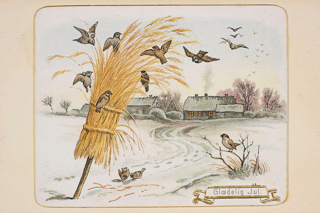 19th century Danish holiday card with birds feeding on a sheaf of wheat in a snowy rural landscape.