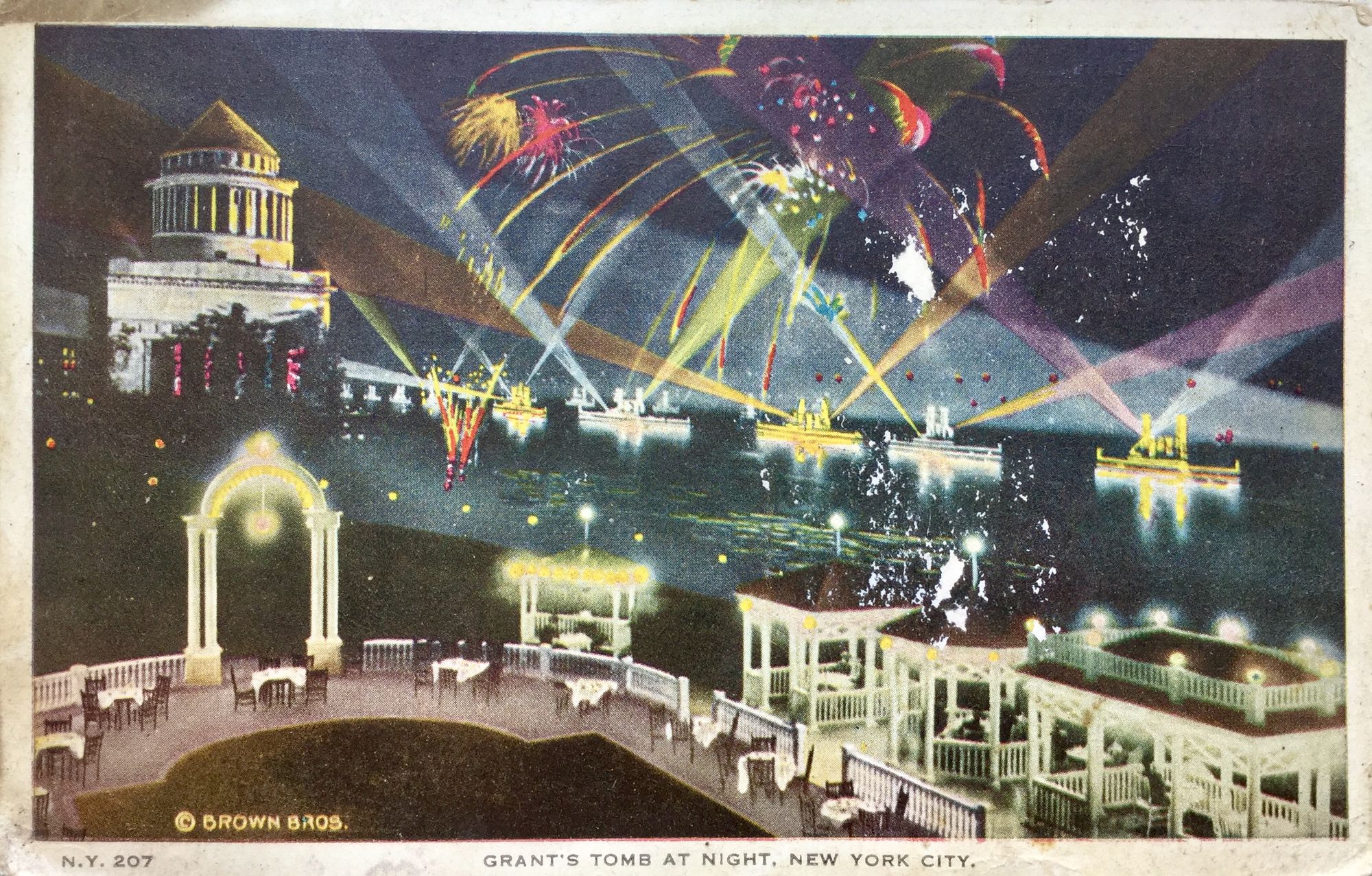 Archival postcard featuring "Grant's Tomb at Night, New York City." Barges line the nearby river, shooting fireworks off their decks.