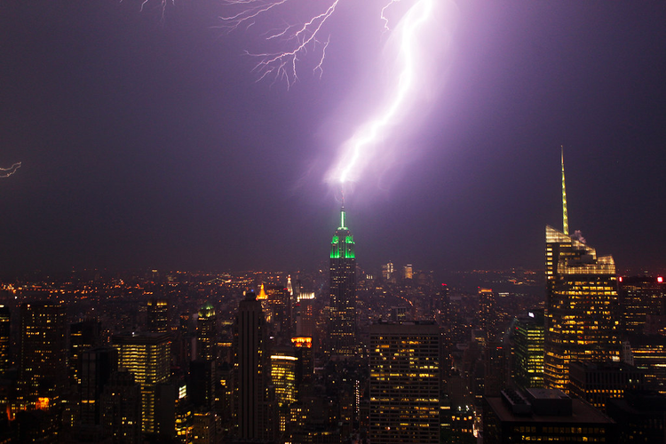 A thick streak of lightning quivers between the top of the Empire State Building and the heavens above Manhattan's skyline.